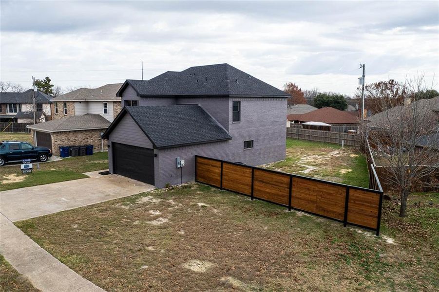 View of property exterior with a yard and a garage