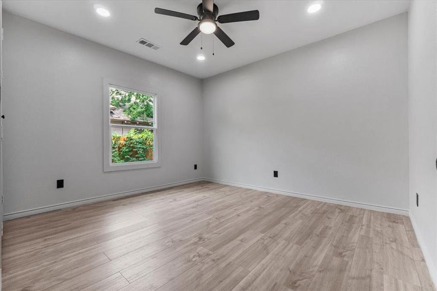 Spare room with light wood-type flooring and ceiling fan