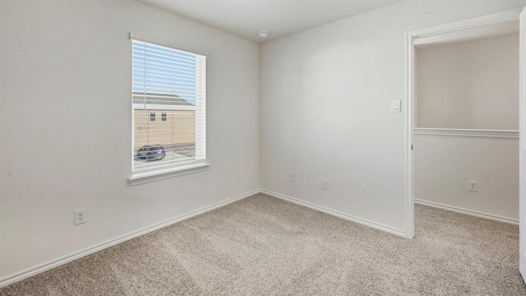 Carpeted spare room with baseboards