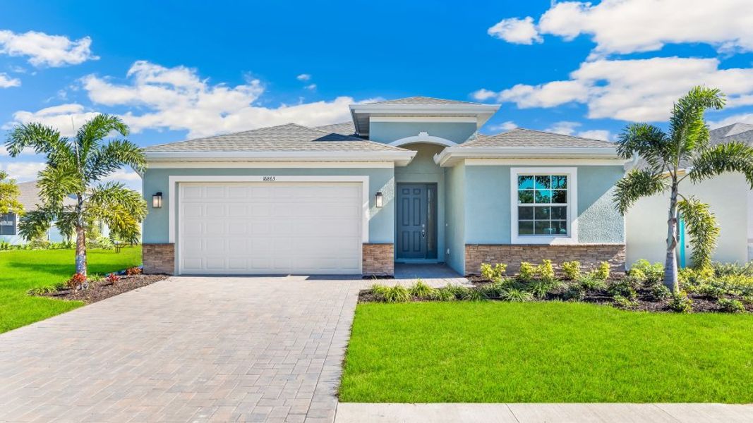 Front exterior of a new home in Coral Bay - Express & Tradition, North Fort Myers, FL, highlighting curb appeal (Image 1).