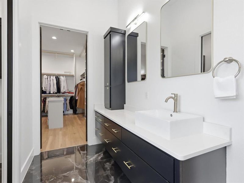 Bathroom vanity featuring a rectangular vessel sink, brushed nickel faucet, and quartz countertop