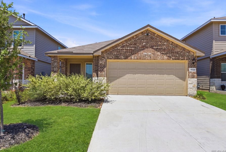 Front exterior of a new home in Avenida, Converse, TX, highlighting curb appeal (Image 18). Front exterior of a new home in Avenida, Converse, TX, highlighting curb appeal (Image 18).