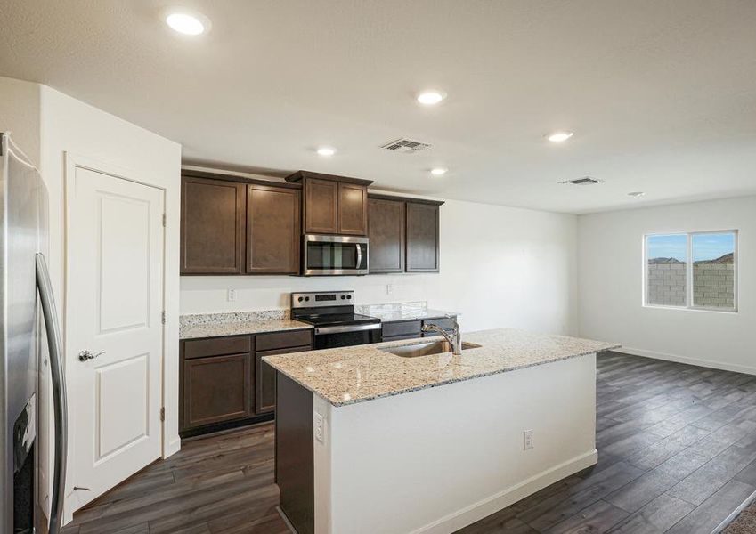 This kitchen has a beautiful granite island.