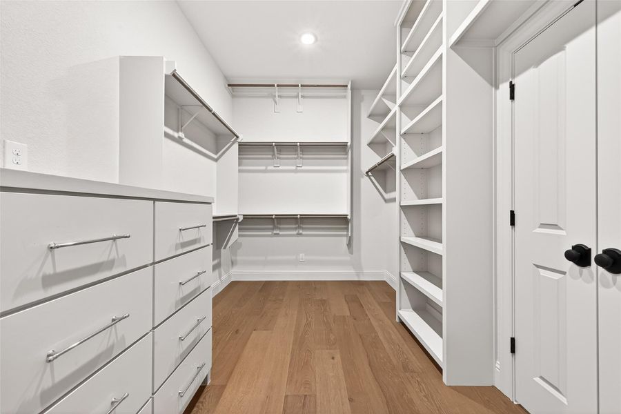 Primary closet full of built ins to keep this space organized!