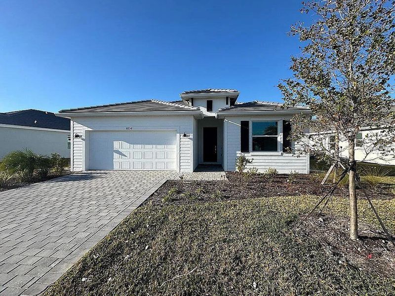 Front exterior of a new home in , Englewood, FL, highlighting curb appeal (Image 1).