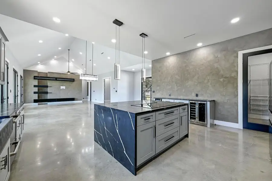 The gorgeous oversized waterfall island offers inviting bar seating that everyone will want to gather around with plenty of space for more than one chef prepping meals at once. The gorgeous oversized waterfall island offers inviting bar seating that everyone will want to gather around with plenty of space for more than one chef prepping meals at once.