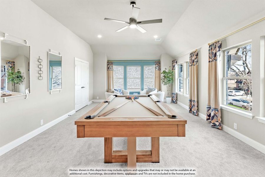 Game room with wood pool table, vaulted ceiling, ceiling fan, and large windows with decorative curtains Game room with wood pool table, vaulted ceiling, ceiling fan, and large windows with decorative curtains