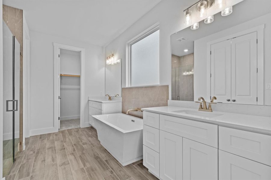 Bathroom with separate shower and tub, vanity, and wood-type flooring