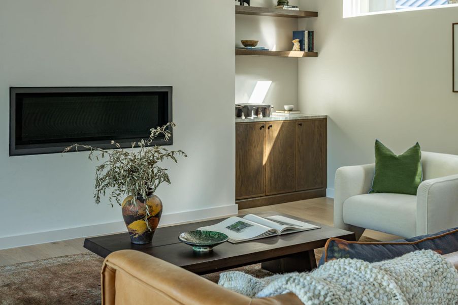 Sleek built-in cabinetry and a modern fireplace create a refined architectural focal point. Sleek built-in cabinetry and a modern fireplace create a refined architectural focal point.