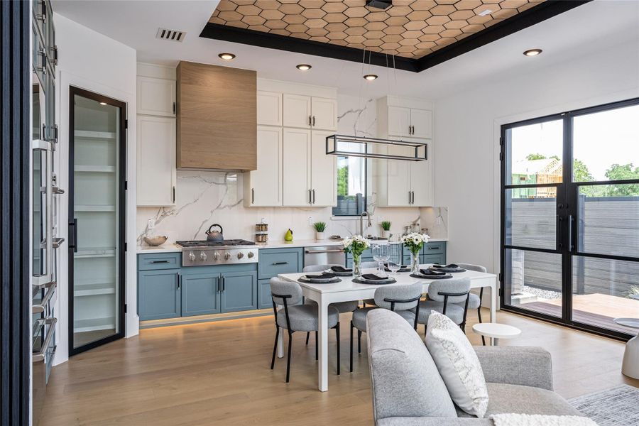 Enjoy two-tone custom cabinetry in designer hues, luxurious porcelain countertops, and full-height backsplash. A glass-framed pantry with interior countertop and GE Café appliances complete this dream kitchen Enjoy two-tone custom cabinetry in designer hues, luxurious porcelain countertops, and full-height backsplash. A glass-framed pantry with interior countertop and GE Café appliances complete this dream kitchen