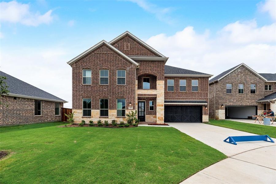 Front exterior of a new home in Valencia On The Lake, Little Elm, TX, highlighting curb appeal (Image 1).