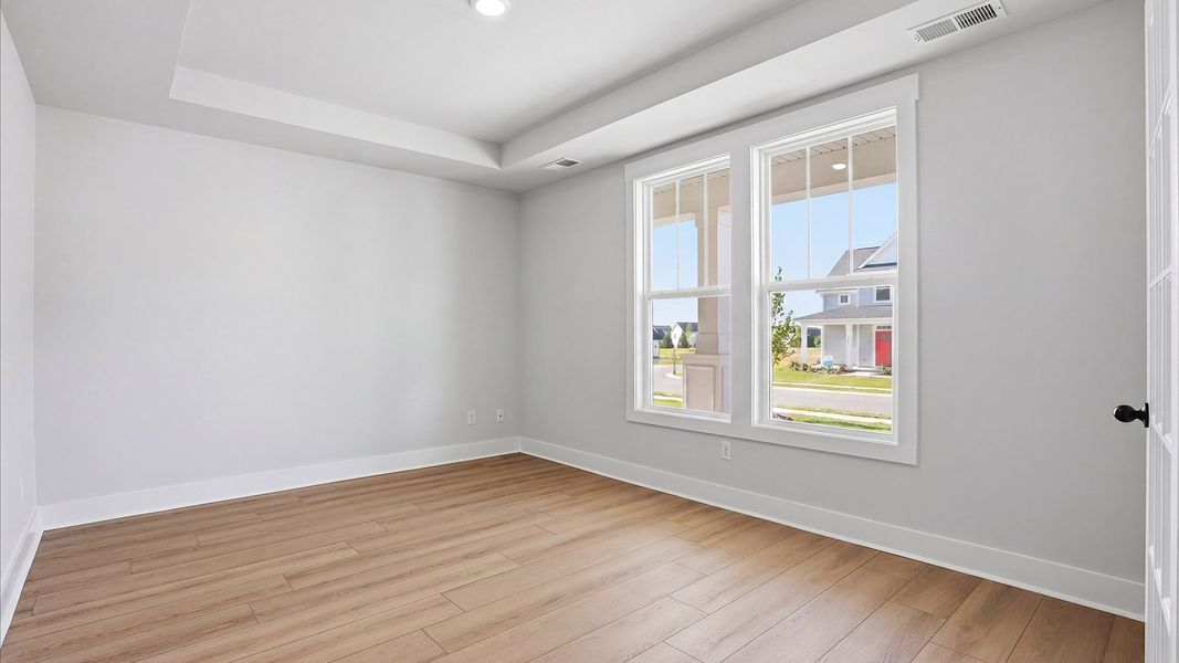 Vibrant natural light and tasteful design define this French door study near the front of the home at Benjamin's Grove Vibrant natural light and tasteful design define this French door study near the front of the home at Benjamin's Grove