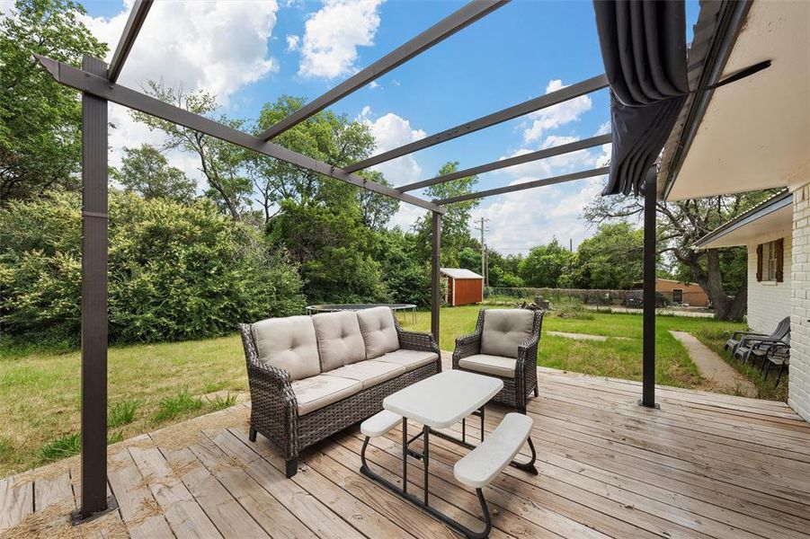 Wooden deck featuring an outdoor living space and view of scattered trees Wooden deck featuring an outdoor living space and view of scattered trees