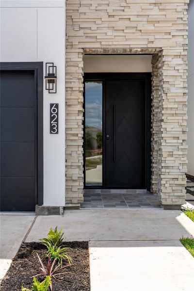 A grand stone entrance is anchored by a heavy-duty cast-iron front door with toughened glass sidelights—welcoming you into the heart of luxury A grand stone entrance is anchored by a heavy-duty cast-iron front door with toughened glass sidelights—welcoming you into the heart of luxury