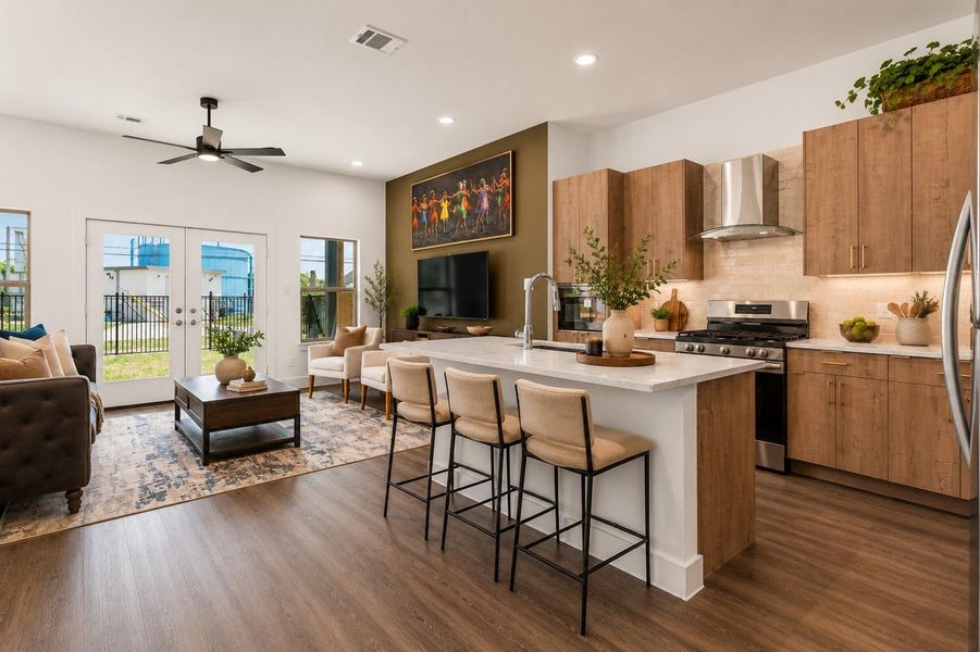 Contemporary island kitchen featuring quartz countertops, stainless steel appliances, soft-close cabinetry, and modern designer finishes throughout.