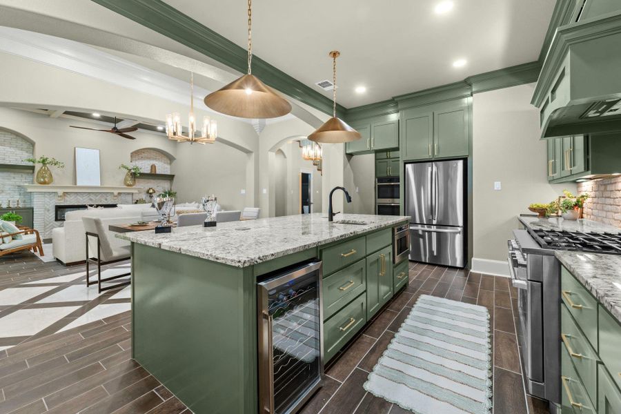 Contemporary kitchen featuring green cabinetry, granite countertops, and wood-finish flooring