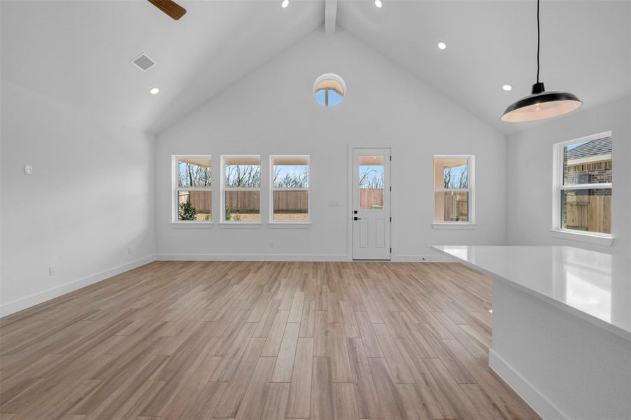 Bright and open living area with vaulted ceilings (*Photo not of actual home and used for illustration purposes only.)