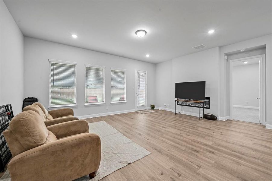 Living room featuring light wood finished floors and recessed lighting
