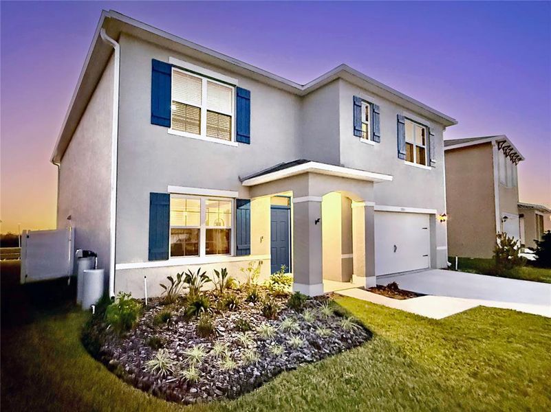 Front exterior of a new home in Lakes at Laurel Highlands, Lakeland, FL, highlighting curb appeal (Image 29).