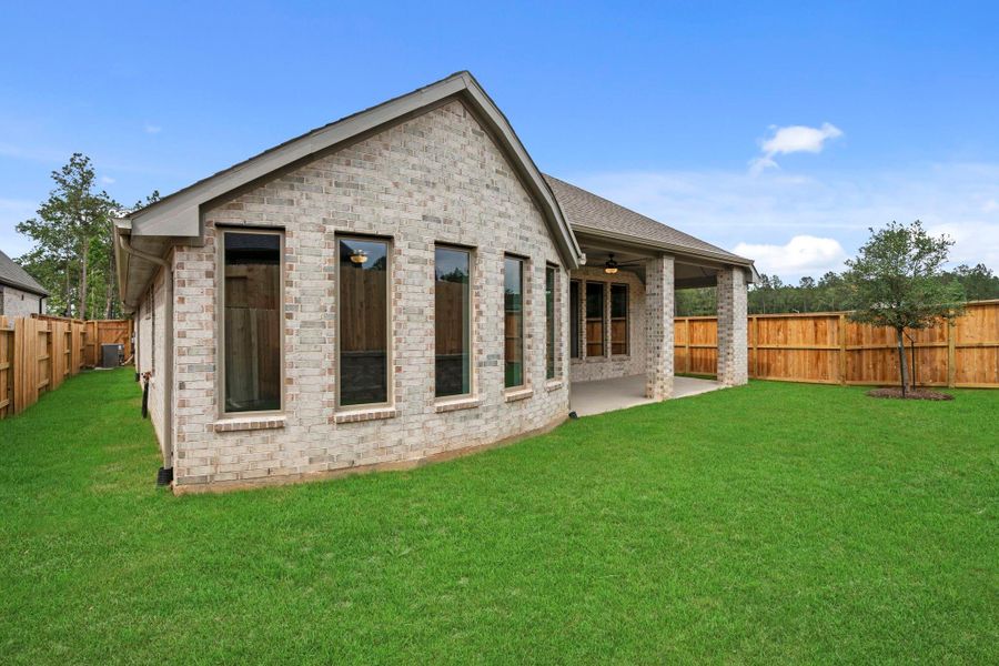 Exterior details and patio area of a home in Wildtree, Magnolia (Image 23).