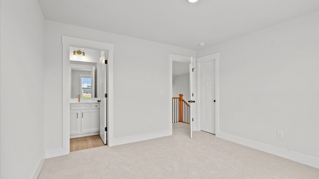 Accomplished design shines in this carpeted bedroom with a functional walk-in closet Accomplished design shines in this carpeted bedroom with a functional walk-in closet
