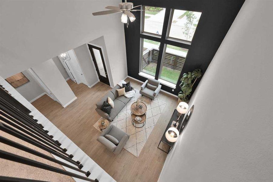 Open railing detail overlooking the living room highlights the airy, modern design. (Original Builder Staged Photo 2024)