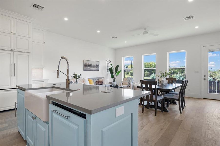 Kitchen featuring blue cabinets, light wood-type flooring, white cabinets, recessed lighting, and a center island with sink Kitchen featuring blue cabinets, light wood-type flooring, white cabinets, recessed lighting, and a center island with sink