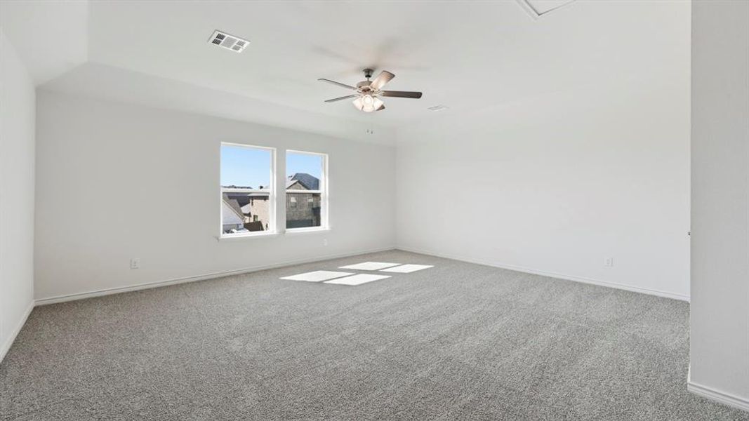 Unfurnished room featuring light carpet and a ceiling fan Unfurnished room featuring light carpet and a ceiling fan