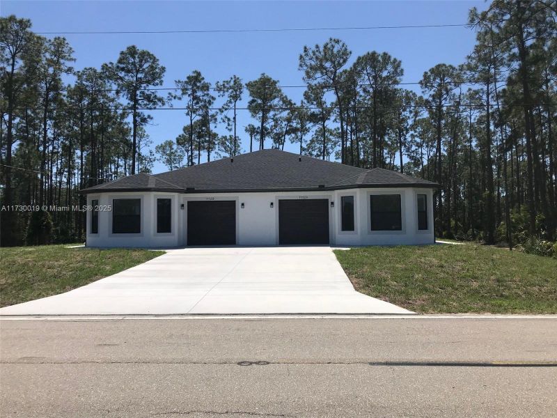 Front exterior of a new home in , Lehigh Acres, FL, highlighting curb appeal (Image 1).