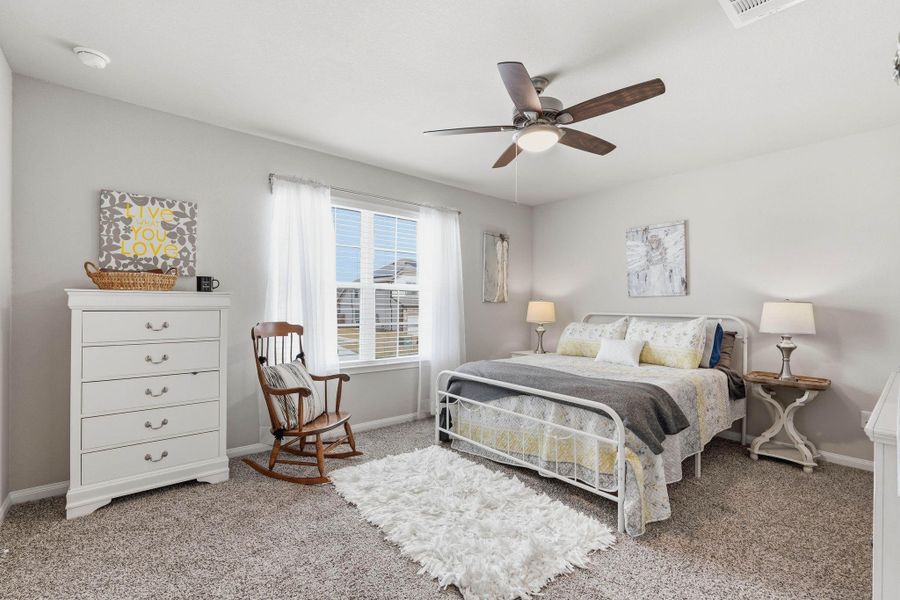 Large secondary bedroom with ceiling fan and closet