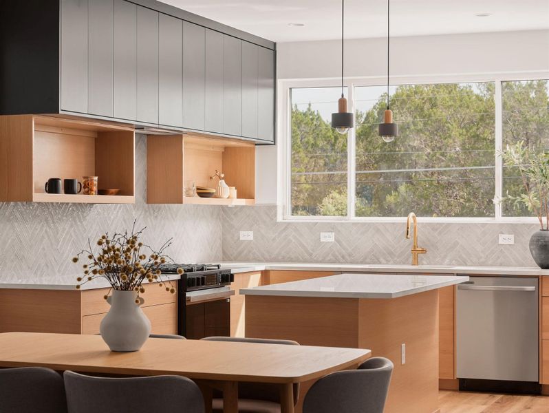 Kitchen with hanging light fixtures, modern cabinets, dishwasher, black gas stove, and decorative backsplash