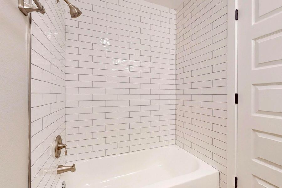 Full bath featuring bathtub / shower combination in hall.