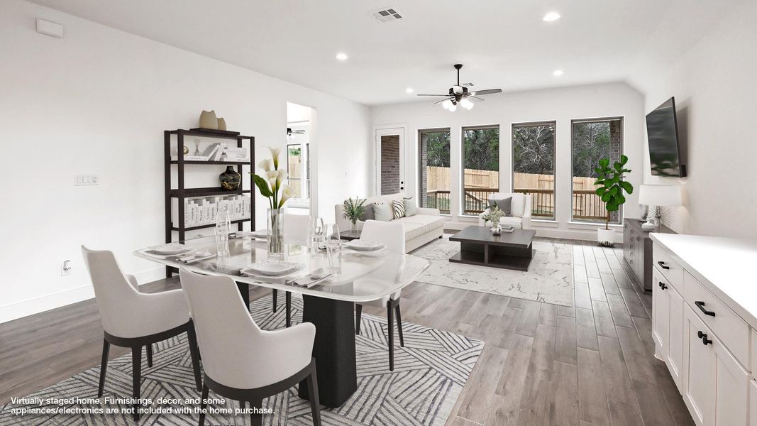 Dining area with wood finished floors, a ceiling fan, recessed lighting, and baseboards Dining area with wood finished floors, a ceiling fan, recessed lighting, and baseboards
