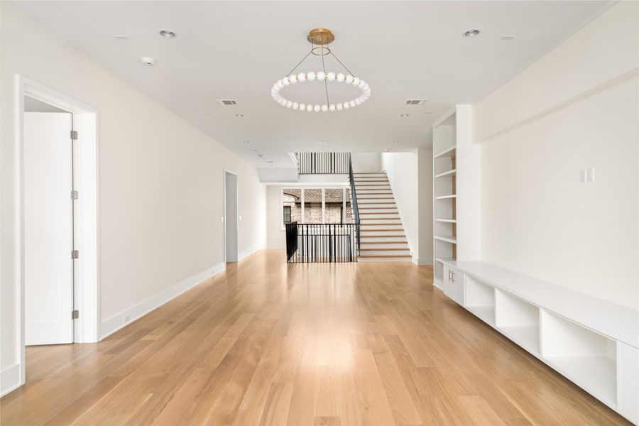 An alternate view highlights the game room’s seamless connection to the upper level with open sightlines and effortless flow.