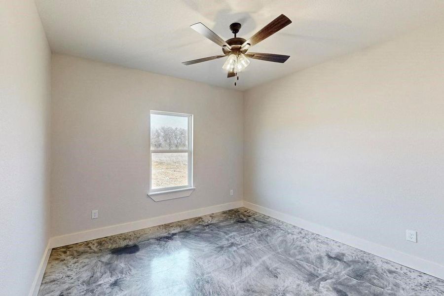 Unfurnished room featuring a ceiling fan and baseboards