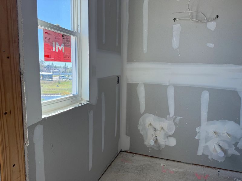 Primary en-suite bathroom with an additional window
