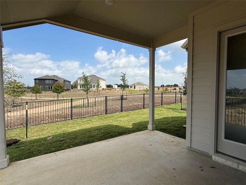 Fenced backyard featuring a patio and a residential view Fenced backyard featuring a patio and a residential view