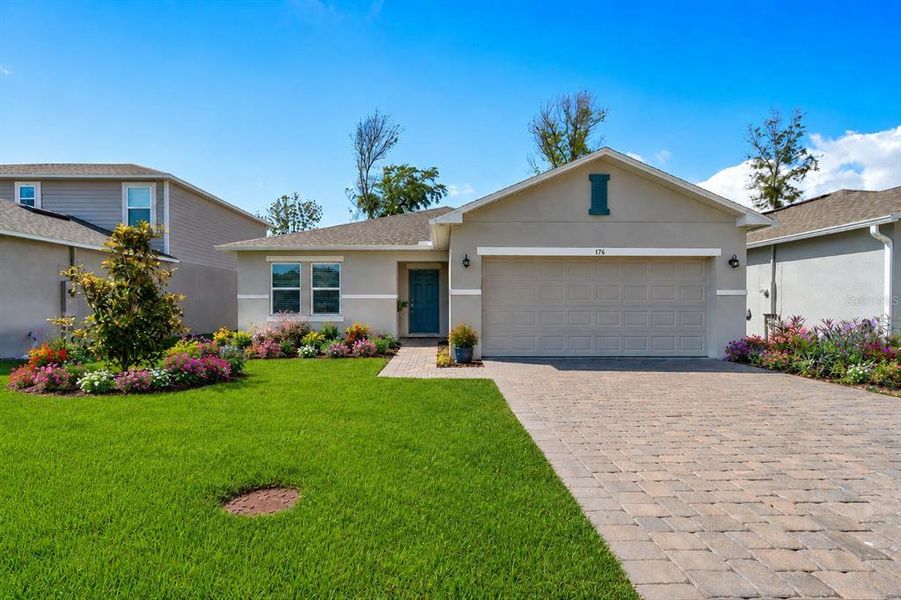 Front exterior of a new home in Riverfront, Edgewater, FL, highlighting curb appeal (Image 1). Front exterior of a new home in Riverfront, Edgewater, FL, highlighting curb appeal (Image 1).