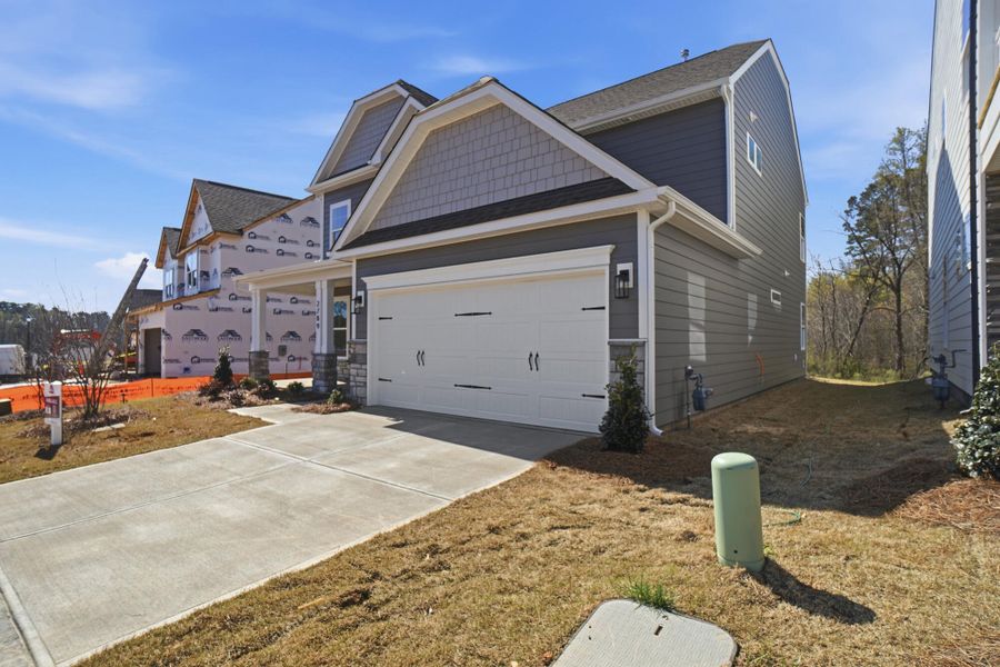 Front exterior of a new home in Ashton Park, Monroe, NC, highlighting curb appeal (Image 23). Front exterior of a new home in Ashton Park, Monroe, NC, highlighting curb appeal (Image 23).
