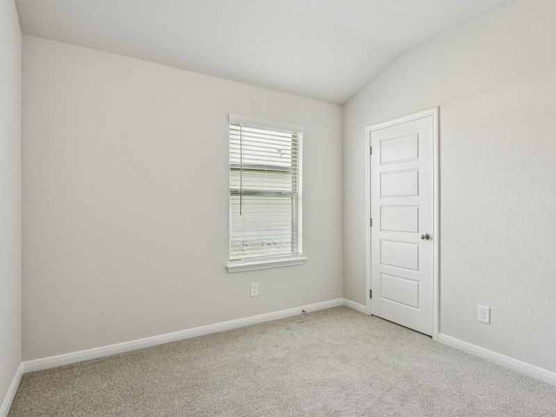 Guest bedroom in the Oleander floorplan at a Meritage Homes community.
