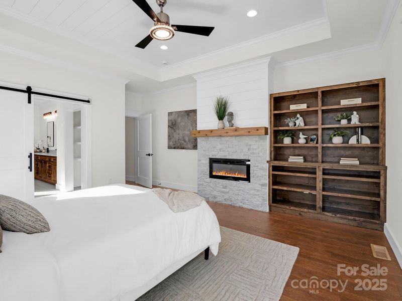 Primary bedroom with gas fireplace and built-ins