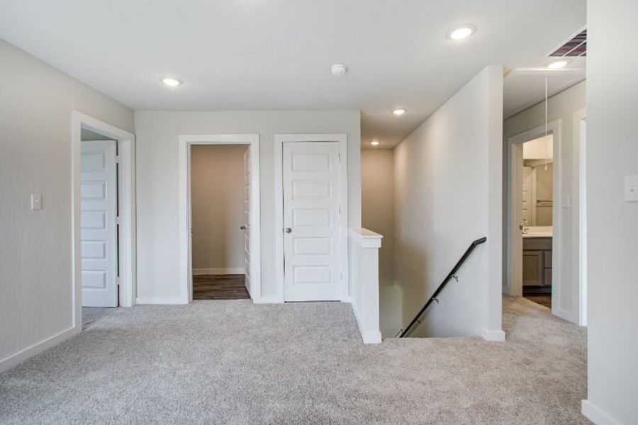 A hallway with white doors. A hallway with white doors.