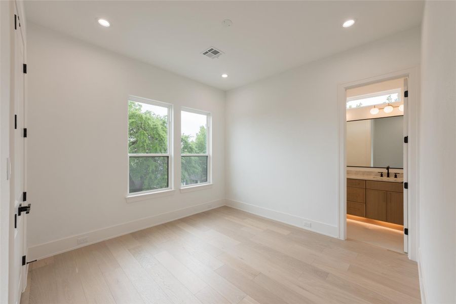 Another view of the second secondary bedroom with lush landscaping from your window view.
