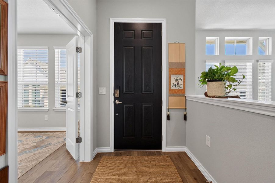 A welcoming entry features hardwood flooring and abundant natural light from high-set and transom windows. A welcoming entry features hardwood flooring and abundant natural light from high-set and transom windows.