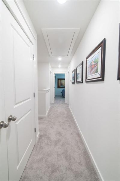 Hall featuring light carpet and attic access