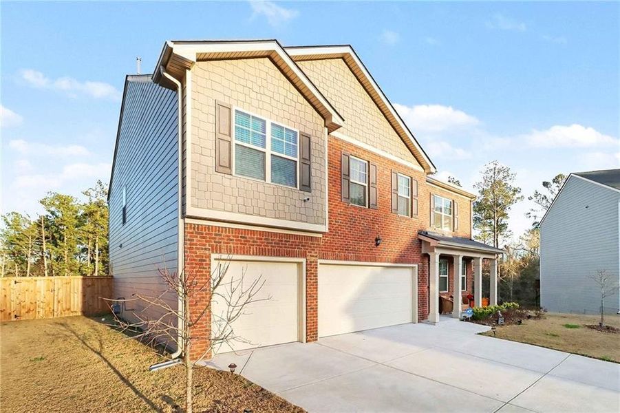 Front exterior of a new home in , Lithonia, GA, highlighting curb appeal (Image 21).