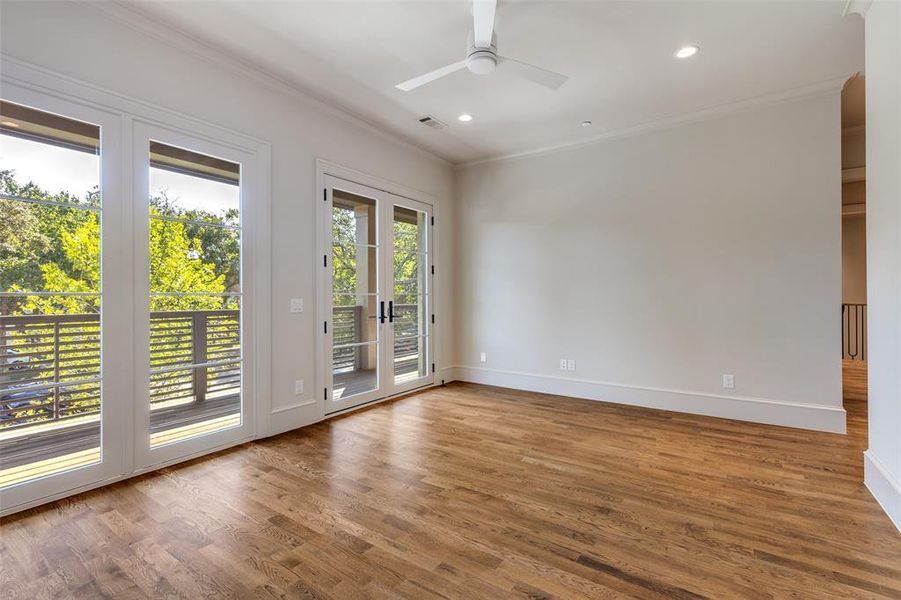 Empty room with crown molding, wood finished floors, recessed lighting, a ceiling fan, and french doors Empty room with crown molding, wood finished floors, recessed lighting, a ceiling fan, and french doors