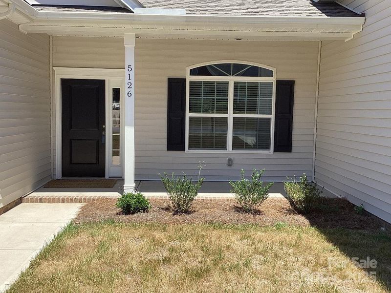 Front exterior of a new home in , Harrisburg, NC, highlighting curb appeal (Image 1).
