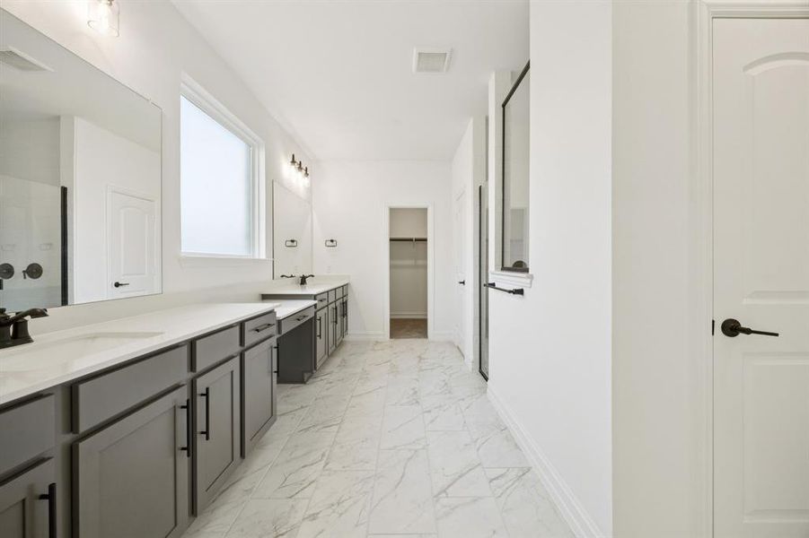 Owner's private bath with double vanity. * Model representation.