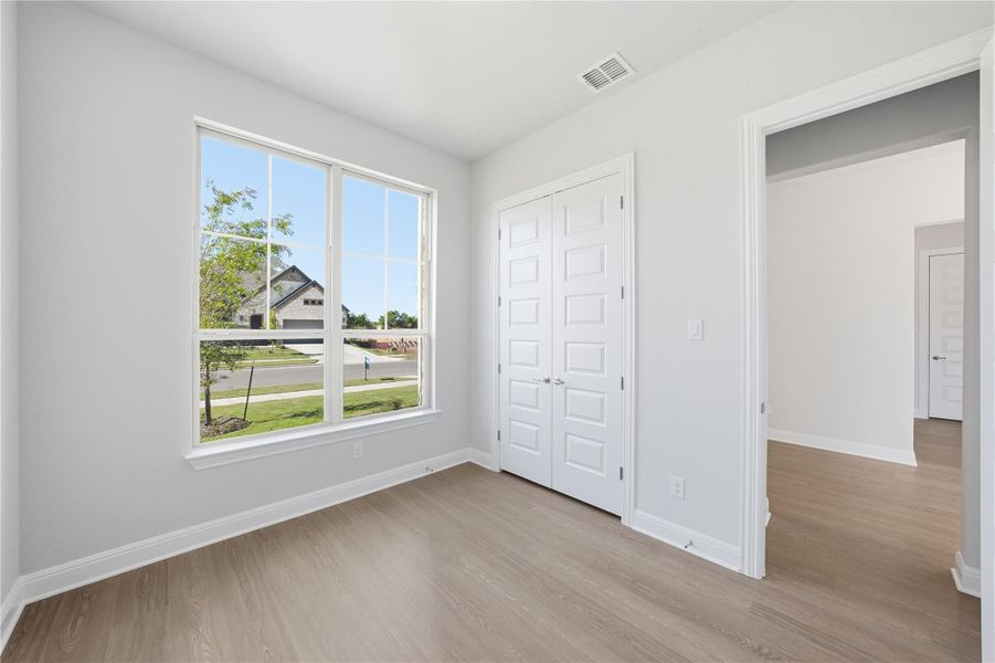 Unfurnished bedroom featuring light wood-style floors and a closet